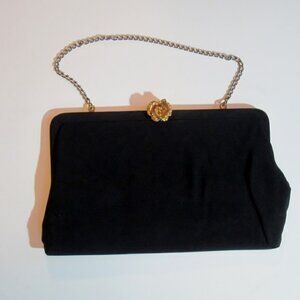 Black cloth clutch bag with gold flower clasp